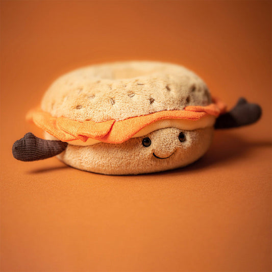 Jellycat Amuseables Bagel plush toy with soft fabric, round shape, and cute facial features, perfect for cuddling or displaying.